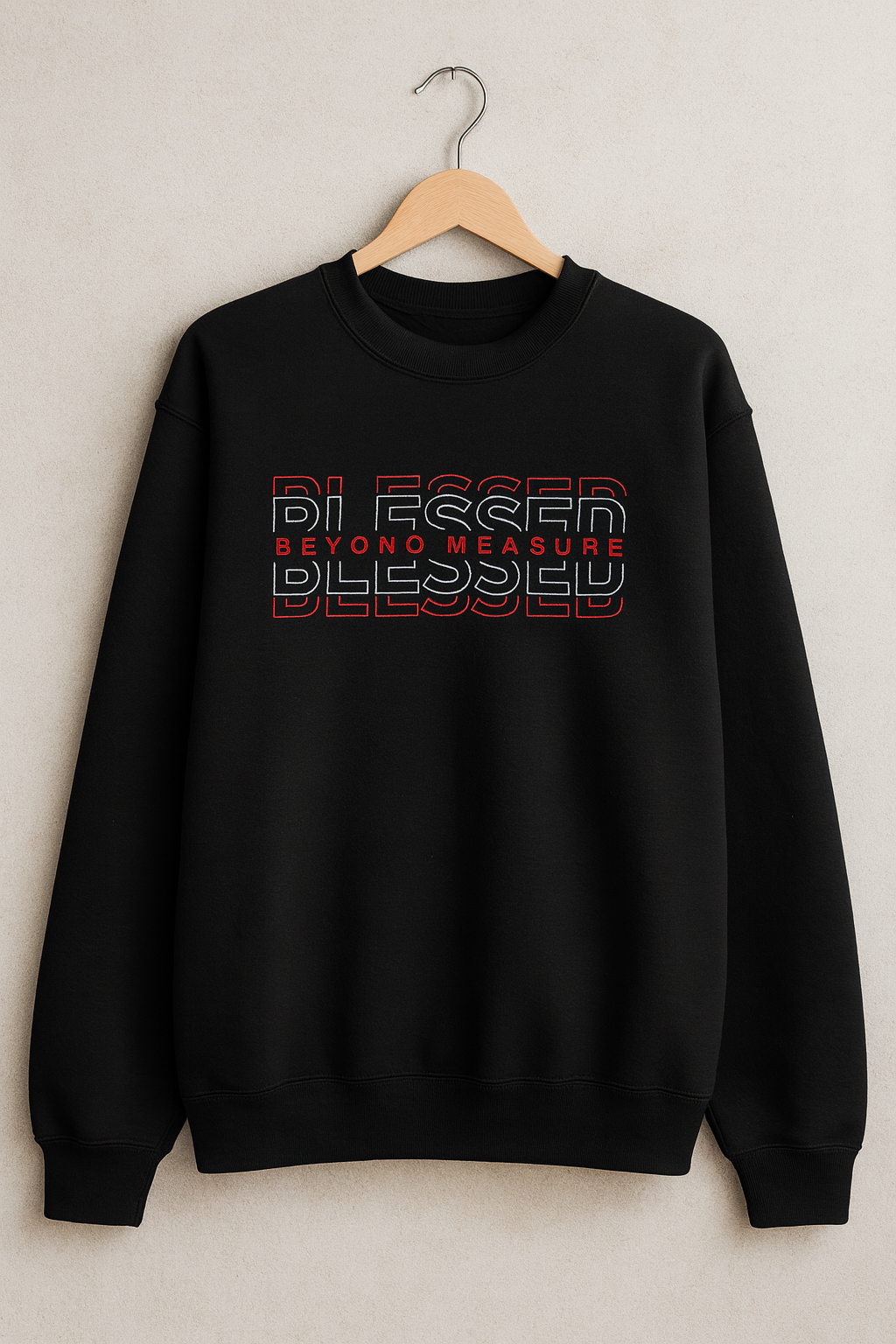 Black sweatshirt with 'Blessed Beyond Measure' text on a hanger against a light background