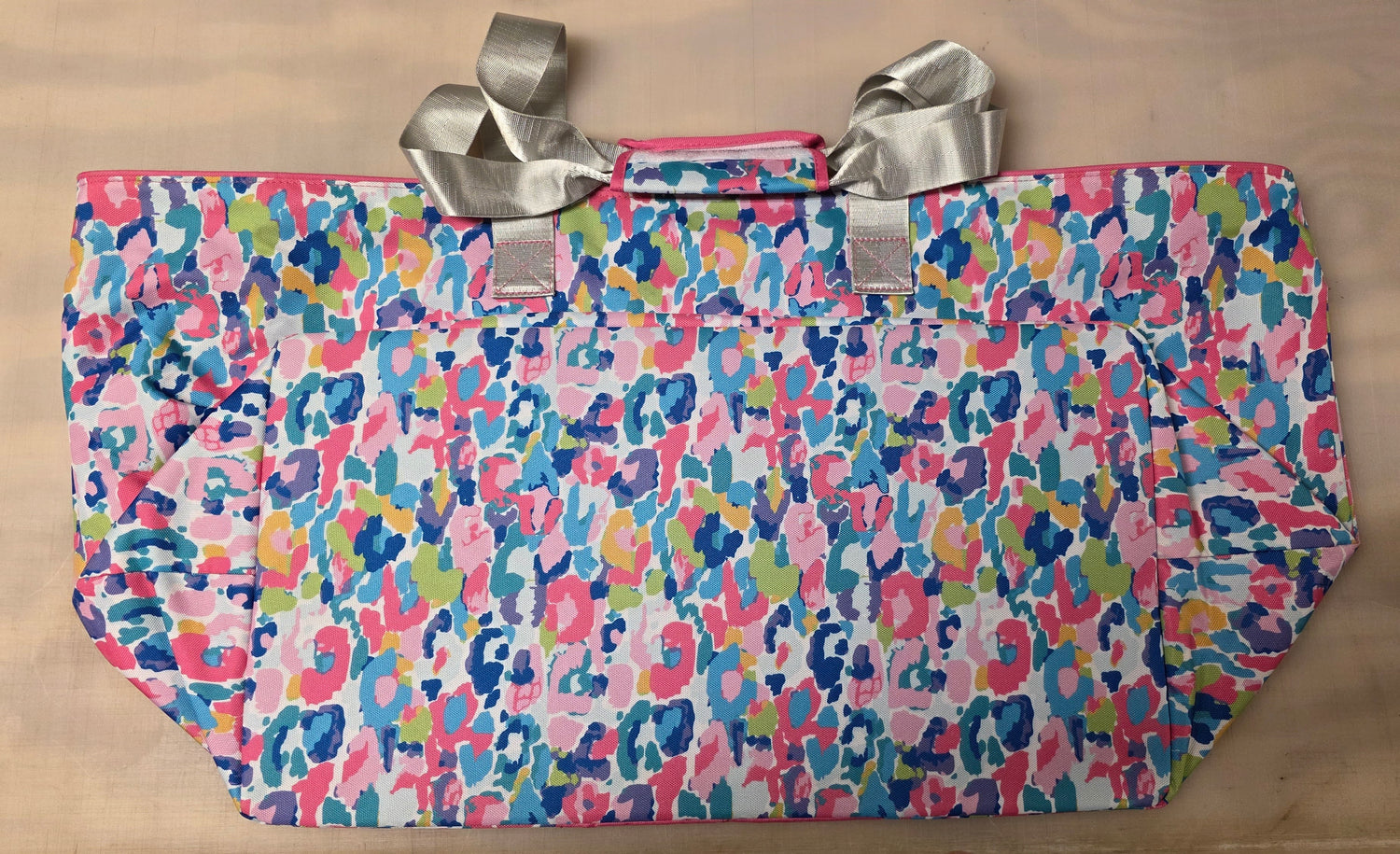 Colorful patterned bag with silver handles.