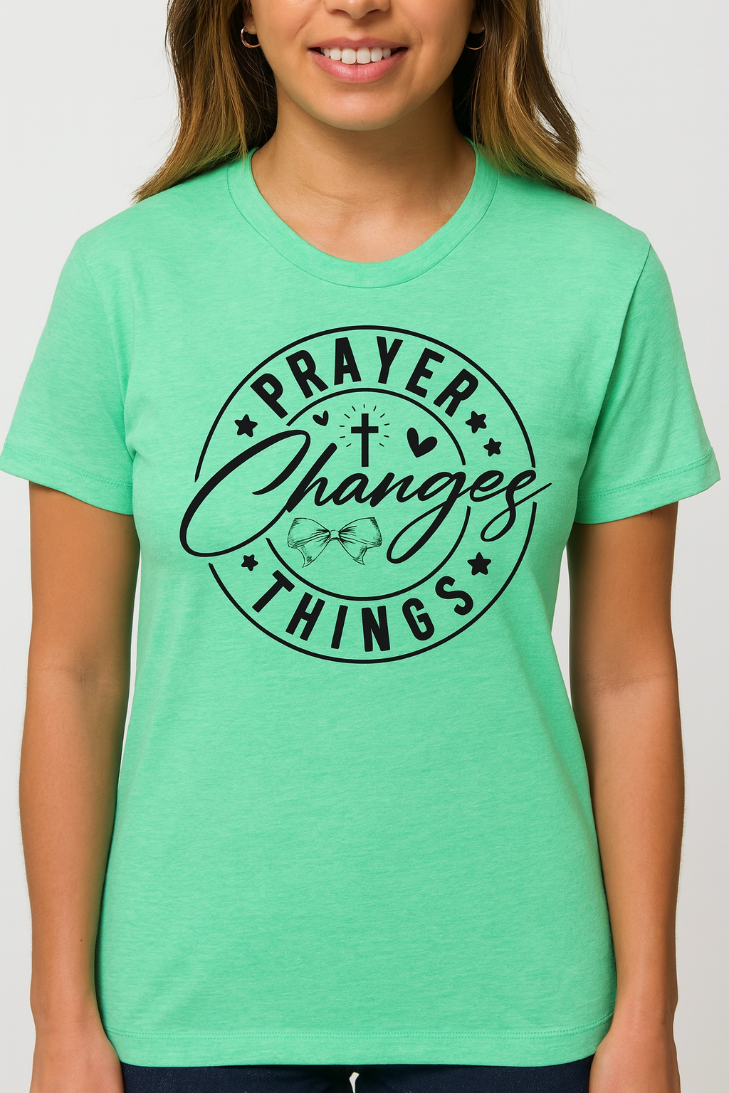 Person wearing a green t-shirt with 'Prayer Changes Things' text design.