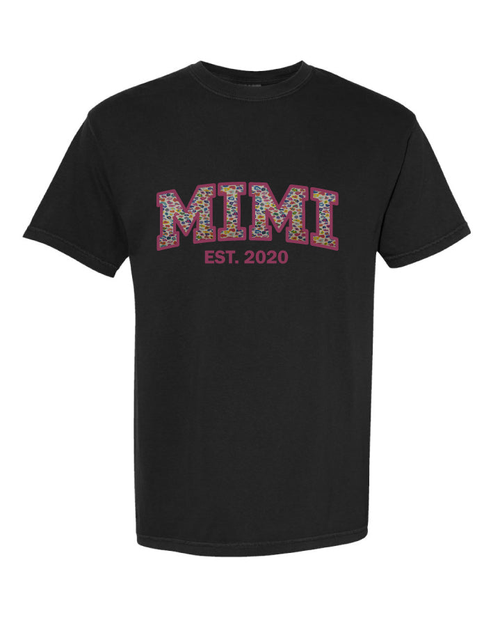 Black t-shirt with 'MIMI EST. 2020' text on a white background