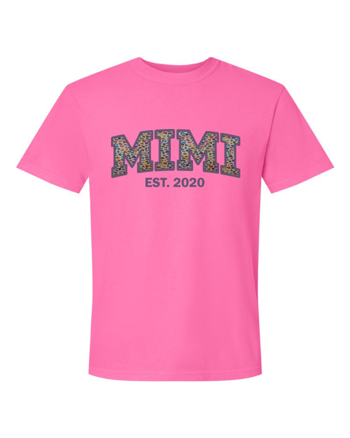 Pink t-shirt with 'MIMI EST. 2020' text on a white background
